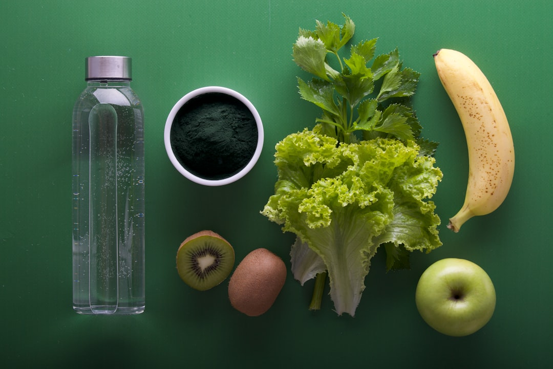 hero image: close-up shot of green superfood powder in bowl alongside fresh leafy greens